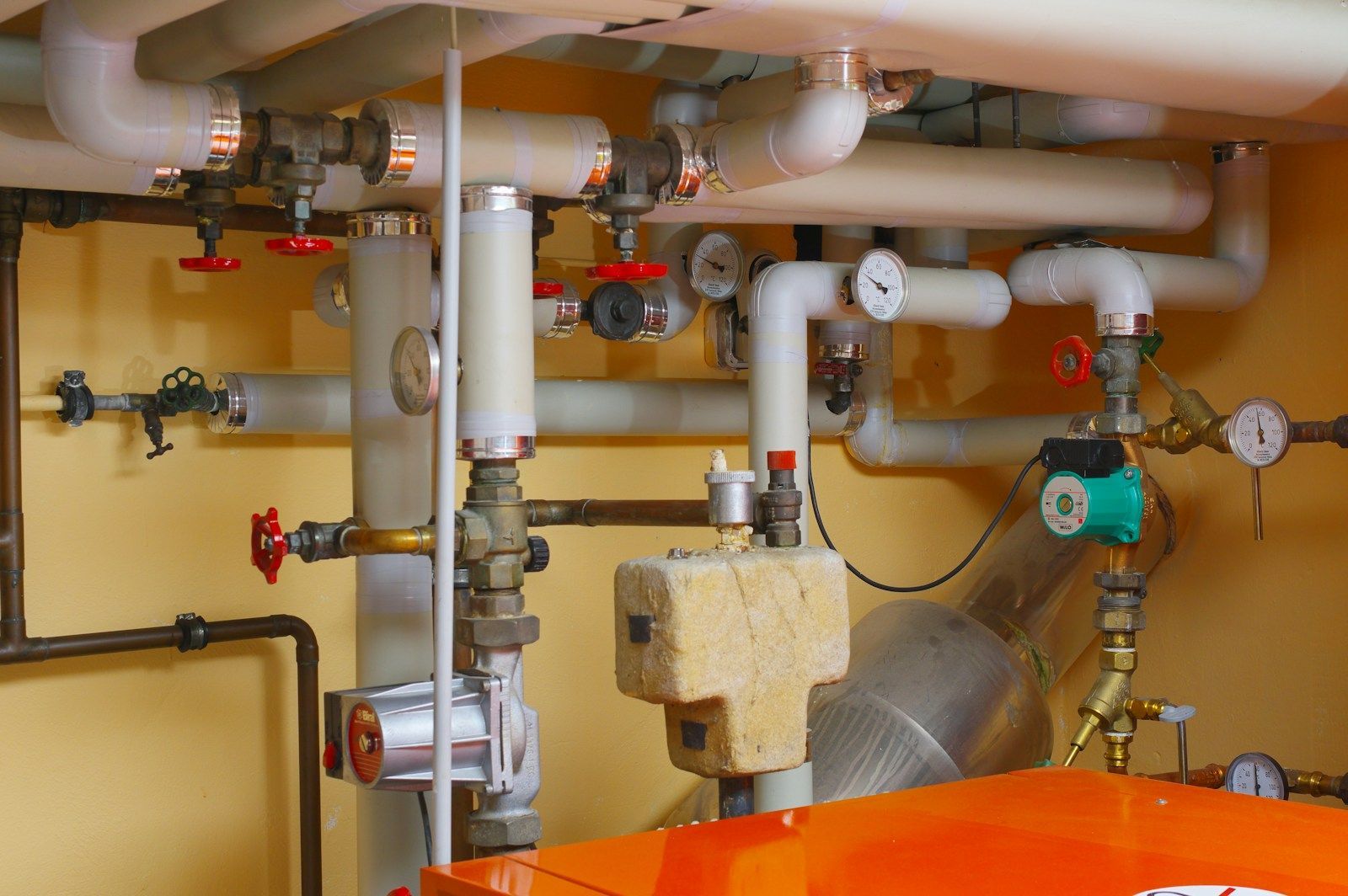Boiler room with pipes, valves and an old boiler